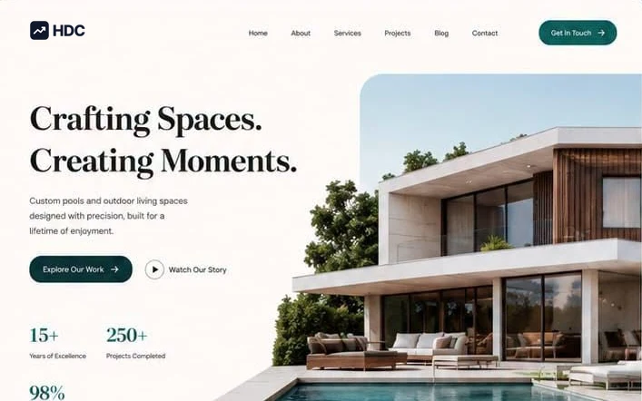 Outdoor living website design concept in warm ivory with deep teal green and black serif type, showing a modern flat-roof house beside a pool under a headline about crafting spaces and creating moments
